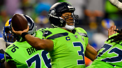 Quarterback (3) Russell Wilson of the Seattle Seahawks puts his hand over  his heart during the National Anthem before playing against the Houston  texans in an NFL football game, Sunday, Dec. 12