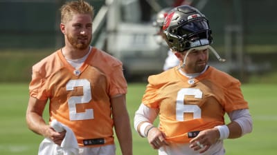 TAMPA, FL - MAY 13: Tampa Bay Buccaneers Logan Hall (90) talks with a team  official before the Tampa Bay Buccaneers Rookie Minicamp on May 13, 2022 at  the AdventHealth Training Center