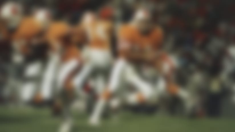 Tampa Bay Buccaneers quarterback and former Heisman trophy winner Vinny Testaverde (14) pitches the ball out during the third quarter of a pre-season game against the Cincinnati Bengals at night on Saturday, August 15, 1987 in Tampa, Florida. It was Testaverde debut as a professional football player. (AP Photo/Jim)