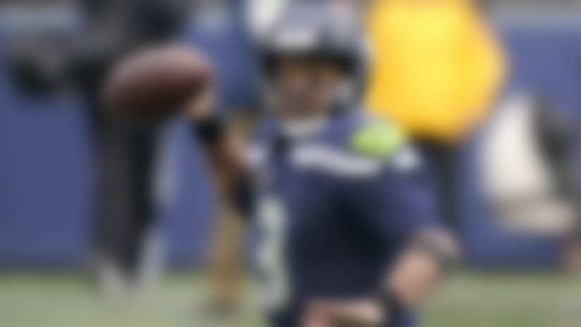 Seattle Seahawks quarterback Russell Wilson readies a pass against the Los Angeles Rams during the first half of an NFL wild-card playoff football game, Saturday, Jan. 9, 2021, in Seattle. (AP Photo/Ted S. Warren)