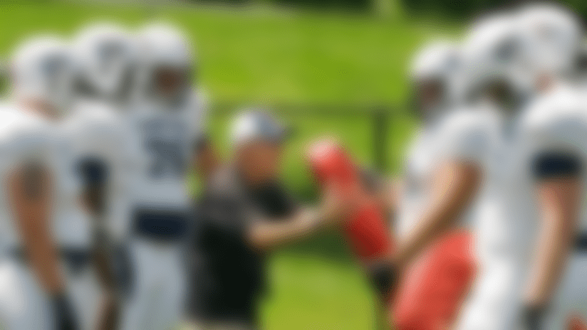 Tackling: In this photograph taken on Tuesday, June 23, 2009, Team USA head coach Chuck Kyle instructs his linemen during football practice in North Canton, Ohio. (AP Photo/Mark Duncan)