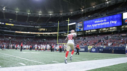 San Francisco 49ers Isaac Bruce smiles to the stands as his team prepares  to run their first play of the game against the St. Louis Rams at the  Edward Jones Dome in