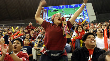 Fans cheer during the NFL's first regular-season game held internationally, between the 49ers and Cardinals in Mexico City in 2005. (Marcu Ugargte/Associated Press)
