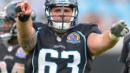 Tony Brackens of the Jacksonville Jaguars stands on the field