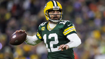 Man Wearing Green American Football Jersey Holding the Ball While