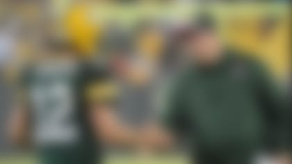 Oct 2, 2014; Green Bay, WI, USA; Green Bay Packers head coach Mike McCarthy congratulates quarterback Aaron Rodgers (12) after a Packers touchdown in the third quarter against the Minnesota Vikings at Lambeau Field. Mandatory Credit: Benny Sieu-USA TODAY Sports