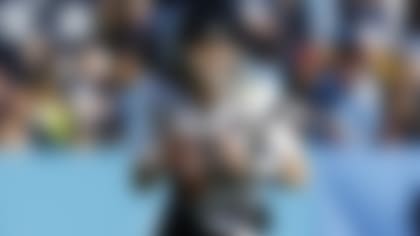 Jacksonville Jaguars quarterback Trevor Lawrence (16) rolls out to throw the ball  during an NFL football game against the Tennessee Titans on Sunday, December 12, 2021 in Nashville, Tennessee. (Logan Bowles/NFL)