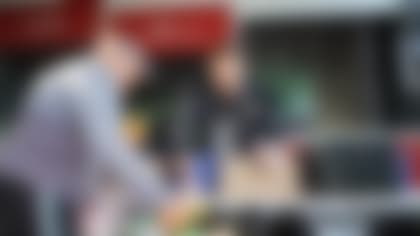 Oakland Raiders punter AJ Cole (6) hands out pears at the Alameda County Community Food Bank Mobile Pantry to sort and distribute food to low-income families at Ashland Village Apartments, Tuesday, November 19, 2019, in San Leandro, Calif.