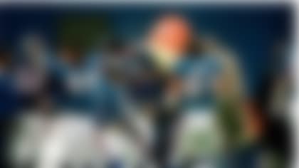 New York Giants head coach Bill Parcells, partly visible at center, is doused by Gatorade tossed by his players in East Rutherford, N.J. Jan. 4, 1987. Purcells is held by Lawrence Taylor (56) as Sean Landeta (5) and Jim Burt look on while Harry Carson, wearing the team doctor's hat and coat tossed the Gatorade. (AP Photo/Susan Ragen)