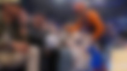 New York Jets quarterback Aaron Rodgers, left, meets with moviemaker Spike Lee, right, during Game 1 in the NBA basketball Eastern Conference semifinals playoff series between the New York Knicks and the Miami Heat, Sunday, April 30, 2023, in New York. (AP Photo/John Minchillo)