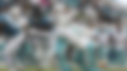 Jacksonville Jaguars running back Tank Bigsby, left, runs for a first down as Miami Dolphins cornerback Noah Igbinoghene (9) defends during the first half of an NFL preseason football game, Saturday, Aug. 26, 2023, in Jacksonville, Fla. (AP Photo/Gary McCullough)