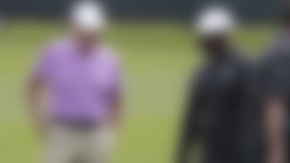 Miami Dolphins general manager Chris Grier, left, owner Stephen Ross, center and head coach Brian Flores, right, talk on the field during voluntary minicamp at the Miami Dolphins NFL football training facility, Wednesday, April 17, 2019, in Davie, Fla. (AP Photo/Lynne Sladky)