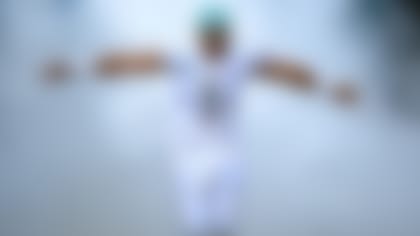 Miami Dolphins quarterback Tua Tagovailoa (1) stretches out his arms as he is introduced to the fans and runs onto the field before an NFL football game between the Houston Texans and the Miami Dolphins, Sunday, Nov. 27, 2022, in Miami Gardens, Fla. (AP Photo/Doug Murray)