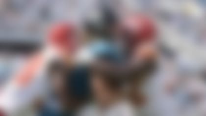 Jacksonville Jaguars quarterback Trevor Lawrence, center, is hit by Kansas City Chiefs cornerback L'Jarius Sneed, left, and Kansas City Chiefs linebacker Nick Bolton, right, during the second half of an NFL football game, Sunday, Sept. 17, 2023, in Jacksonville, Fla. (AP Photo/Phelan M. Ebenhack)