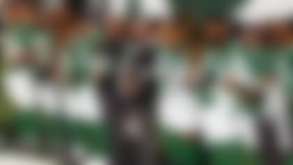 New York Jets owner Christopher Johnson stands with the team during the national anthem before an NFL football game against the Miami Dolphins, Sunday, Nov. 29, 2020, in East Rutherford, N.J. (AP Photo/Adam Hunger)