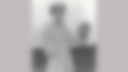 Maurice Britt poses with a football. The former Lions and Arkansas player lost his right arm in the course of his service in World War II. (Courtesy of the Pro Football Hall of Fame)