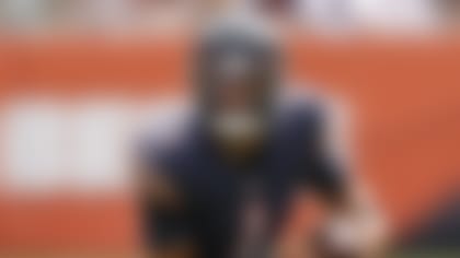 Chicago Bears quarterback Justin Fields (1) rolls out against the Buffalo Bills during the second half of a preseason NFL football game, Saturday, Aug. 21, 2021, in Chicago. (AP Photo/Kamil Krzaczynski)