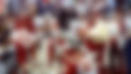 FILE - In this Jan. 22, 1984, file photo, Los Angeles Raiders running back Marcus Allen high-steps his way down the sideline past Washington Redskins' Anthony Washington (24) and Todd Bowles (28) during NFL football's XVIII in Tampa, Fla. Allen rushed for a Super Bowl-record 191 yards on 20 carries and scored two touchdowns as the Raiders trounced the Redskins, 38-9. (AP Photo/File)