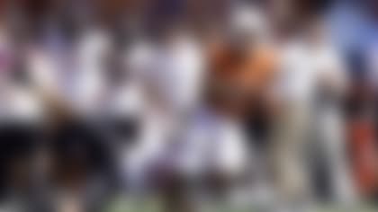 Texas running back Bijan Robinson (5) breaks the tackles of Oklahoma State linebacker Malcolm Rodriguez (20) for a touchdown during the second half of an NCAA college football game in Austin, Texas, Saturday, Oct. 16, 2021. (AP Photo/Chuck Burton)