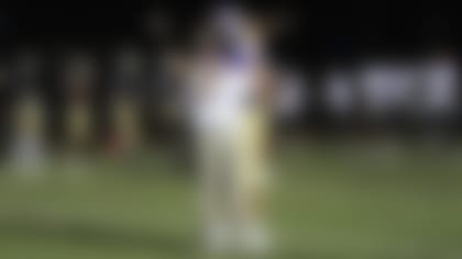 After a win in the same week his grandfather died, CHS coach Joey King received a hug from Lawrence at midfield. (@Trevorlawrencee/Twitter)