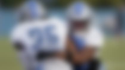 Detroit Lions cornerback Jeff Okudah tackles Cedric Boswell (35) during an NFL football practice in Allen Park, Mich., Monday, Aug. 1, 2022. (AP Photo/Paul Sancya)