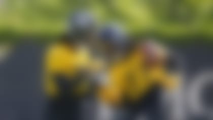 Pittsburgh Steelers second round draft pick, cornerback Joey Porter Jr., left, strips the ball from seventh round pick, defensive back Cory Trice Jr., during the NFL football team's rookie minicamp in Pittsburgh Friday, May 12, 2023. (AP Photo/Gene J. Puskar)