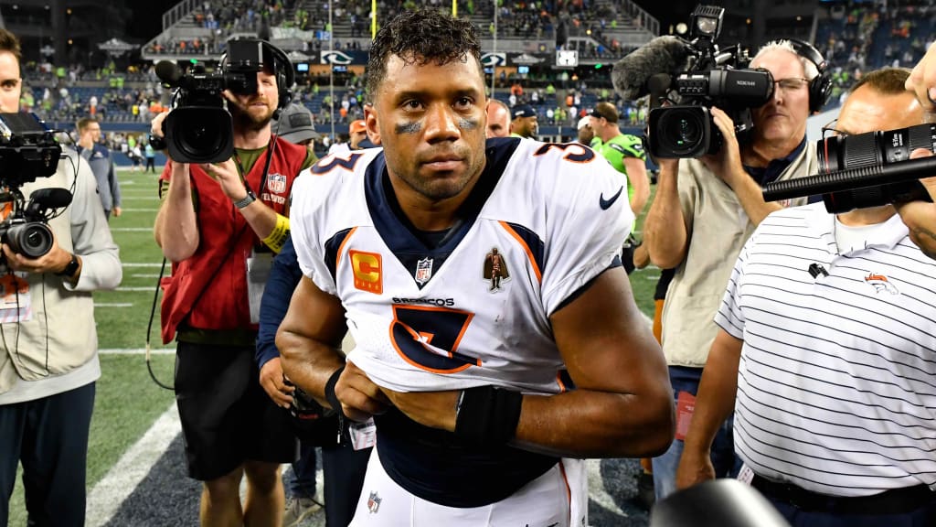 A Seattle Seahawks fan wearing a Russell Wilson jersey waves a towel next  to a Denver Broncos fan wearing a Russell Wilson jersey before an NFL  football game, Monday, Sept. 12, 2022