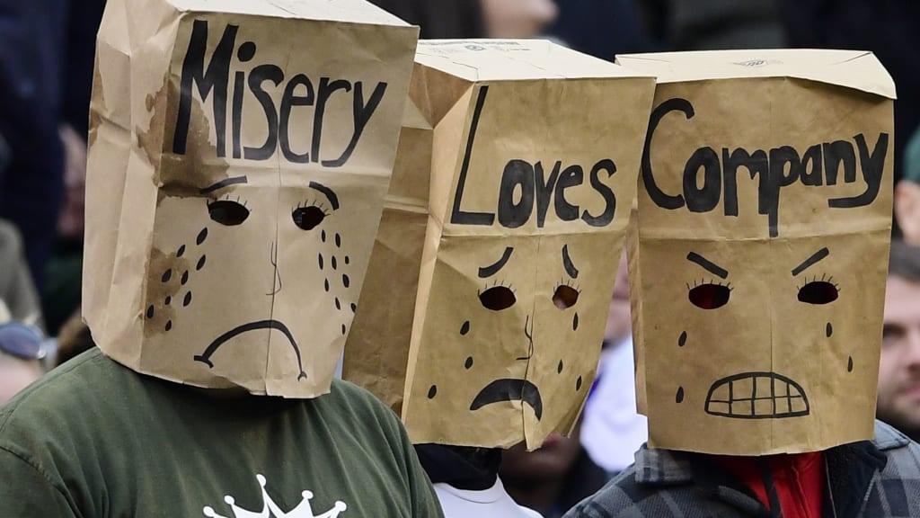 A New York Jets fan wears a bag over their head during the first