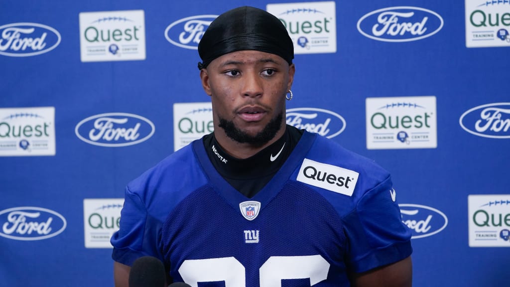 New York Giants running back Saquon Barkley (26) signs his jersey before  swapping it with a member of the Dallas Cowboys after a NFL football game  in Arlington, Texas, Sunday, Sept. 8