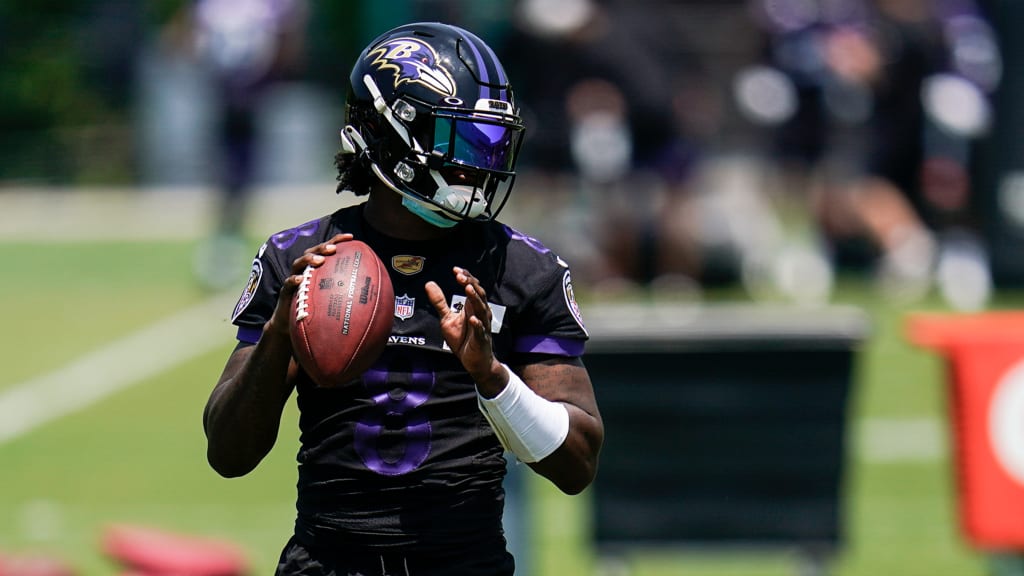 Baltimore Ravens quarterback Lamar Jackson (8) takes to the field with a  member of the military as part of Salute to Service before an NFL football  game against the Carolina Panthers, Sunday