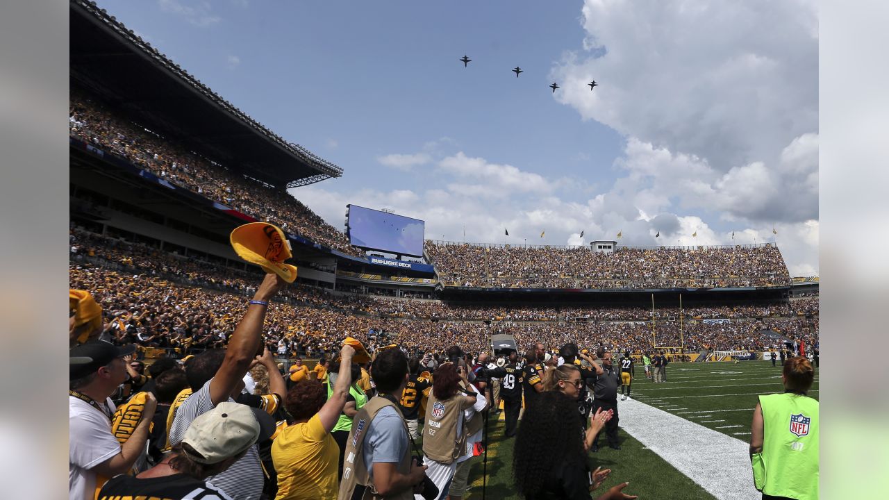 General overall view of military jet fighter plane flyover at Gillette  Stadium during the playing of the national anthem with a United States flag  on the field before an AFC Divisional Playoff