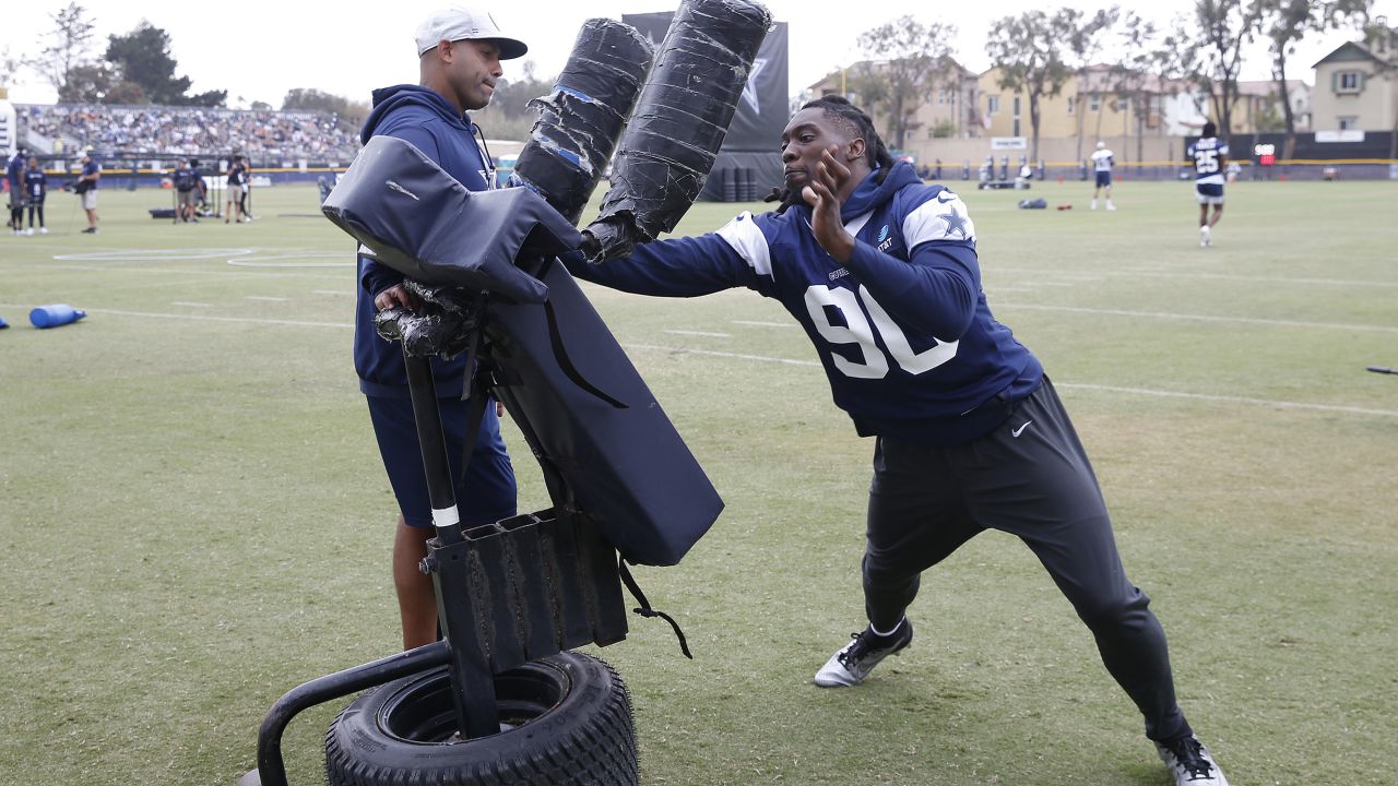 Dallas Cowboys quarterback Dak Prescott, center, has a conversation with  teammates defensive end DeMarcus Lawrence, left, linebacker Micah Parsons  during the NFL football team's training camp Saturday, July 29, 2023, in  Oxnard