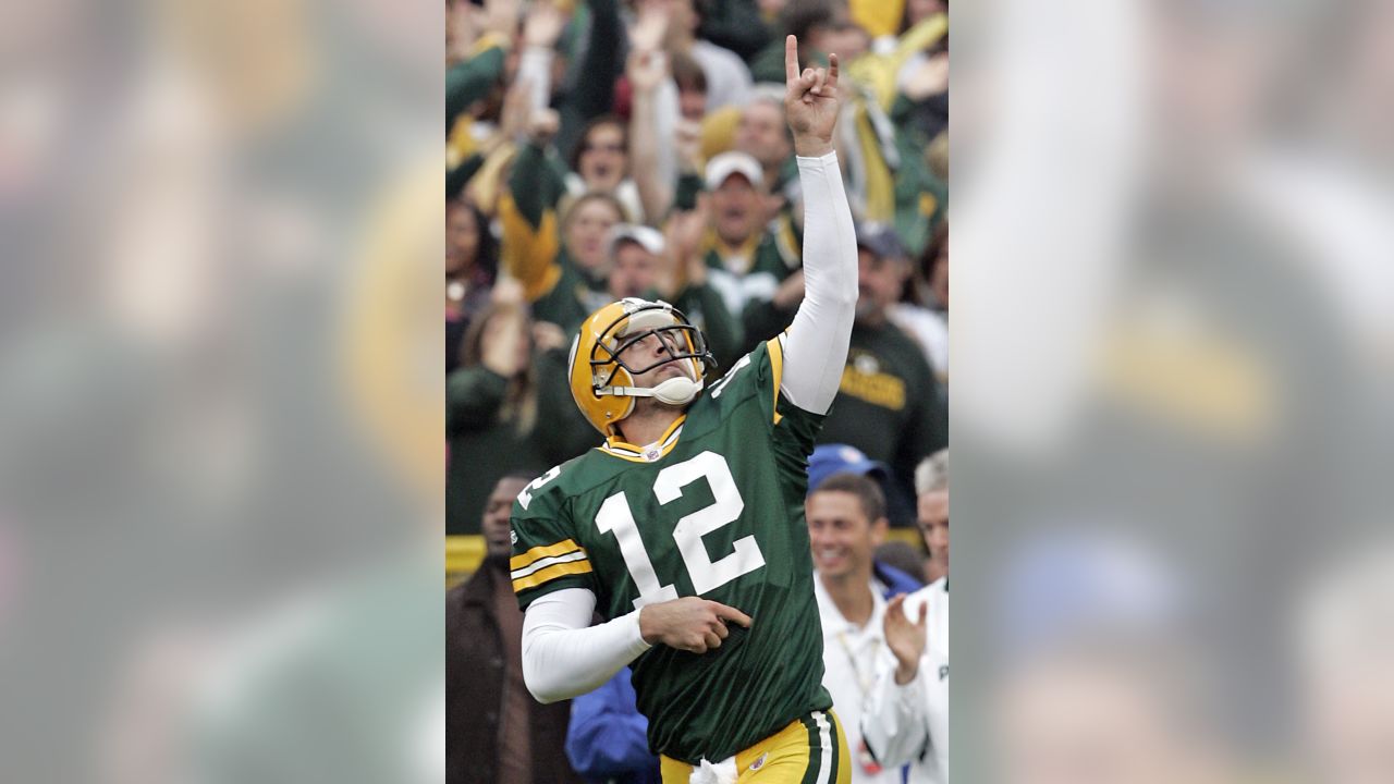 30 November 2008: Green Bay Packers quarterback Aaron Rodgers (12) hands  off the football in the first quarter at Lambeau Field in Green Bay,  Wisconsin. The Panthers defeated the Packers 35-31. (Icon