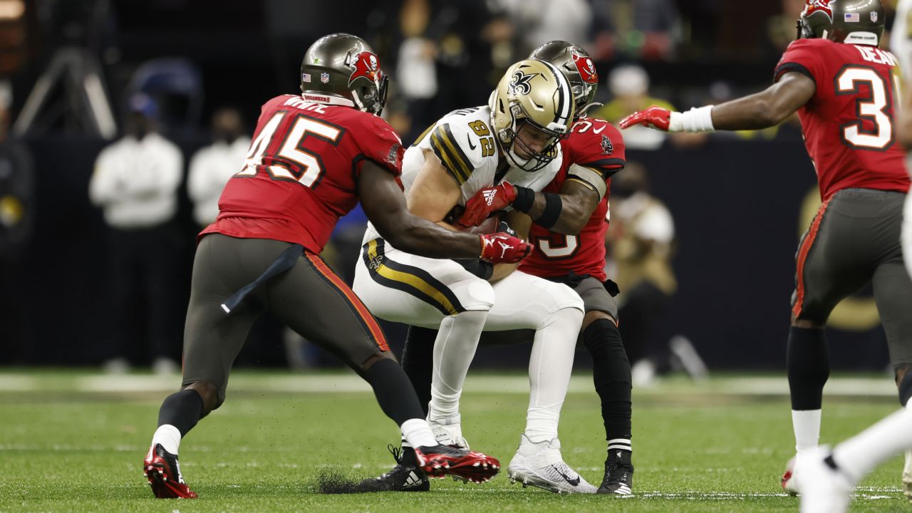 Washington Football Team quarterback Taylor Heinicke, left, rushes the ball  past New Orleans Saints defensive end Cameron Jordan in the first half of  an NFL football game, Sunday, Oct. 10, 2021, in