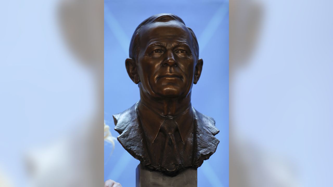 Photo: The Bowlen family with the bust of Pat Bowlen at the Pro