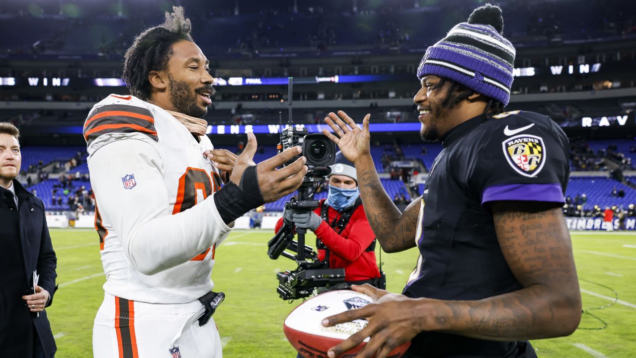 Baltimore Ravens quarterback Lamar Jackson (8) takes to the field with a  member of the military as part of Salute to Service before an NFL football  game against the Carolina Panthers, Sunday