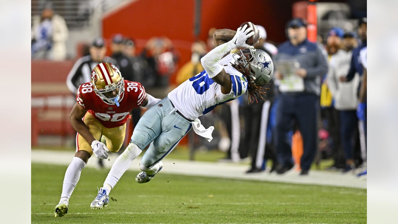 San Francisco 49ers linebacker Fred Warner (54) is tackled by Dallas  Cowboys wide receiver CeeDee Lamb after intercepting a pass during the  first half of an NFL divisional round playoff football game