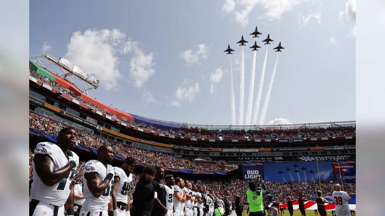 Tampa Bay Buccaneers fans react as a military flyover proceded over the  stadium at the conclusion of the national Anthem before an NFL football  game between the Tampa Bay Buccaneers and the