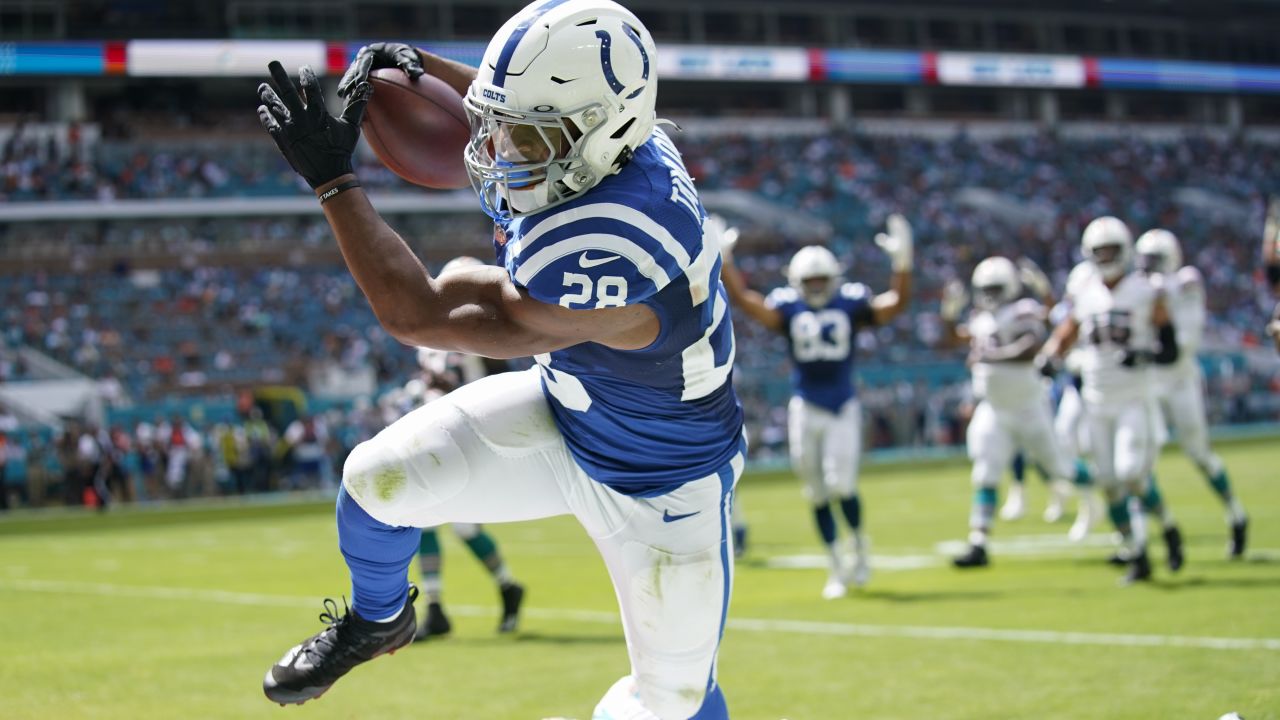 Indianapolis Colts running back Jonathan Taylor (28) tries to run away from  Houston Texans safety Jonathan Owens (36) the NFL football game between the  Indianapolis Colts and the Houston Texans on September