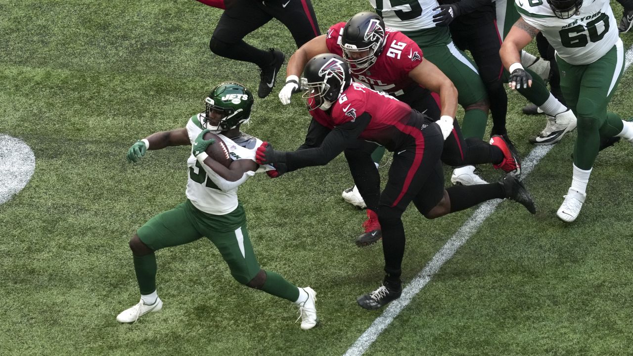 New York Jets running back Michael Carter (32) is tackled during the first  half of an NFL football game between the New York Jets and the Atlanta  Falcons at the Tottenham Hotspur