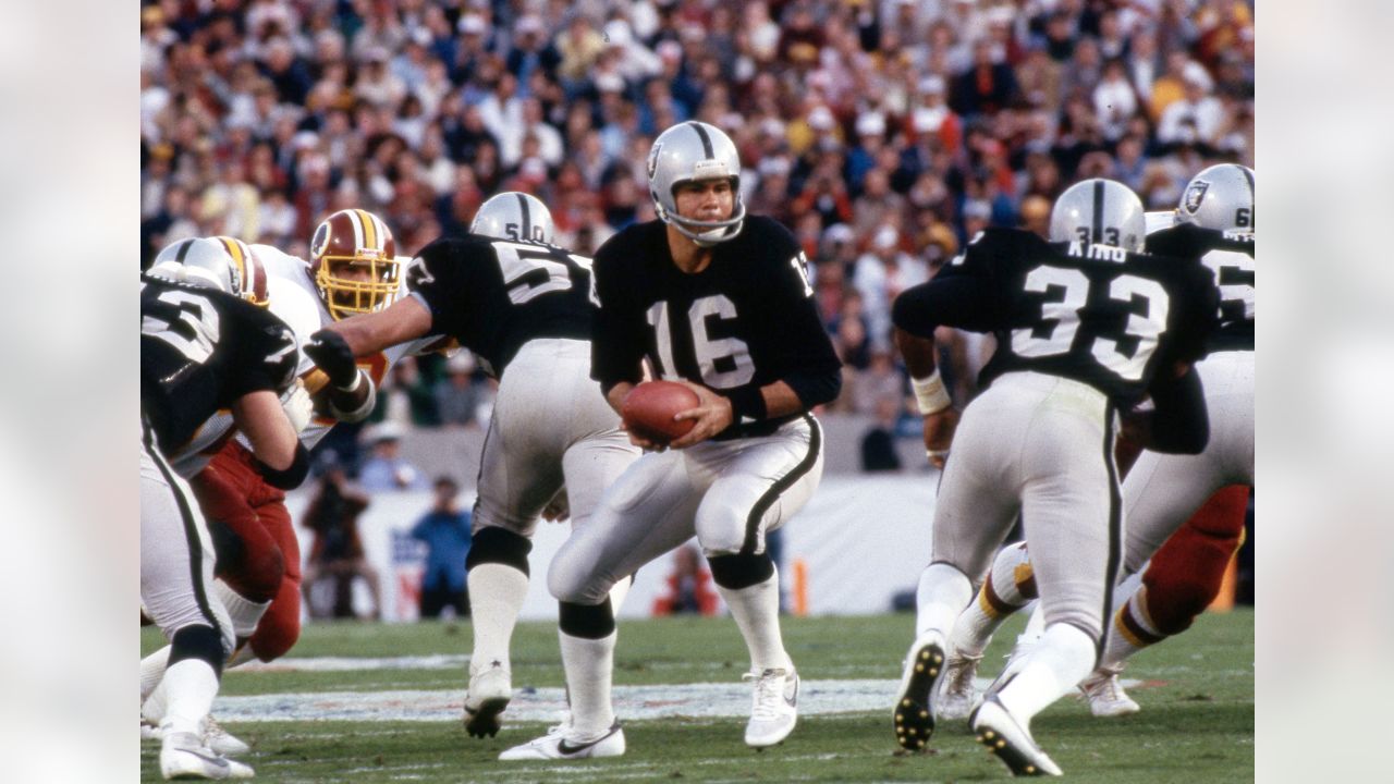 Oakland Raiders quarterback Jim Plunkett (16) prepares to throw the ball in  a game against the …