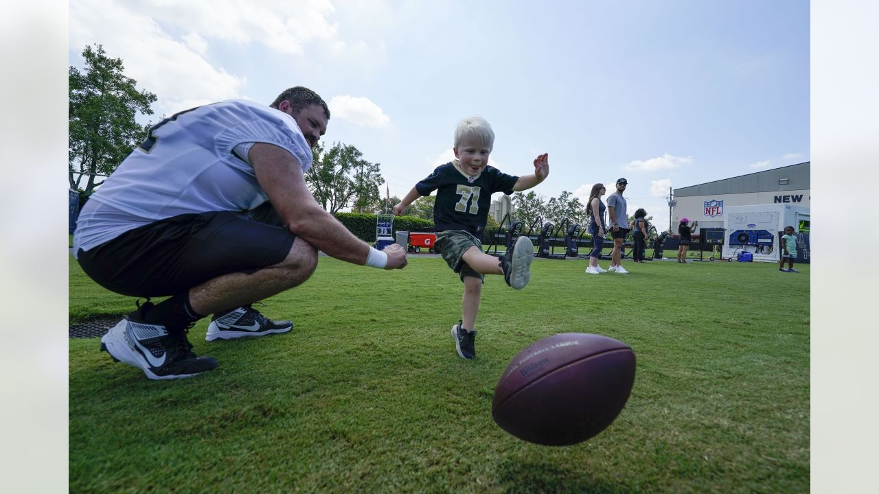 A New Orleans Saints fan waits for the start of practice during the Back  Together Weekend fan appreciation initiative at the NFL team's football  training camp in Metairie, La., Saturday, July 29