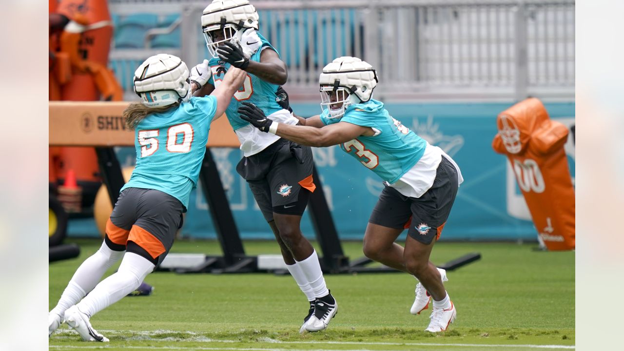 Miami Dolphins linebacker Cameron Goode, right, does drills with Garrett  Crall (50) and Deandre Johnson, center, during the NFL football team's  rookie minicamp, Friday, May 13, 2022, in Miami Gardens, Fla. (AP