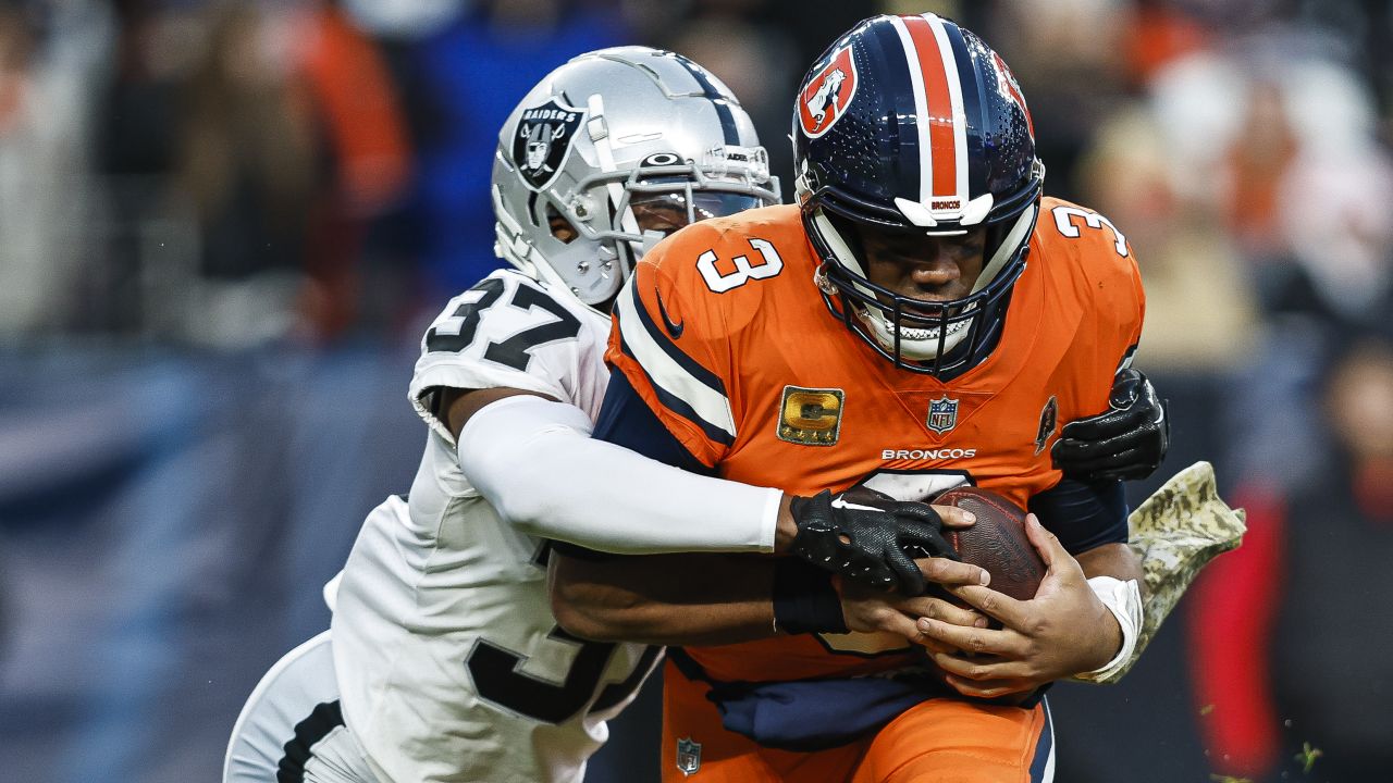 Las Vegas Raiders' Tyler Hall, right, sacks Denver Broncos