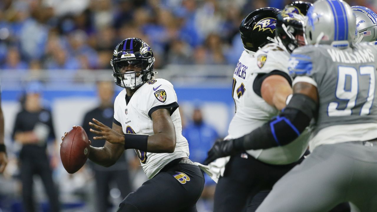 Baltimore Ravens quarterback Lamar Jackson (8) takes to the field with a  member of the military as part of Salute to Service before an NFL football  game against the Carolina Panthers, Sunday