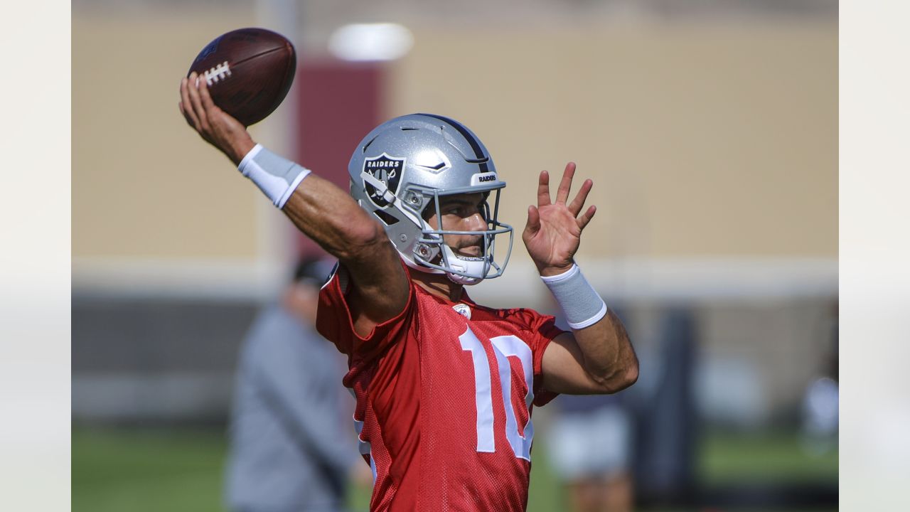 Las Vegas Raiders quarterback Jimmy Garoppolo (10) wipes away