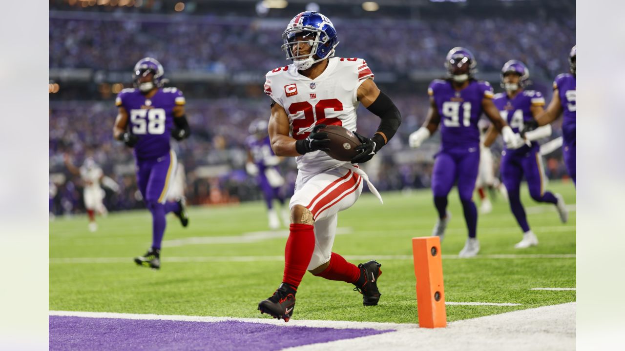 New York Giants running back Saquon Barkley (26) runs up field during the  first half of an NFL wild card playoff football game against the Minnesota  Vikings, Sunday, Jan. 15, 2023, in