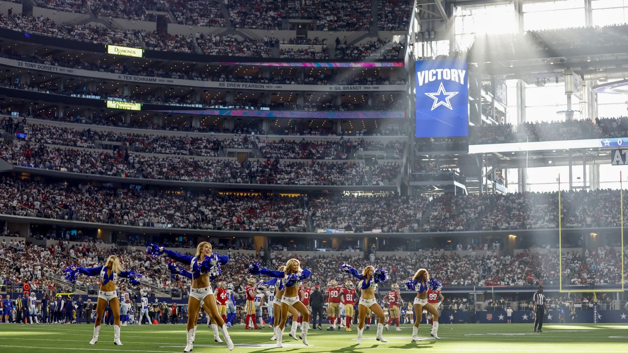 Fans cheer as teams warm up before an NFL wild-card football game