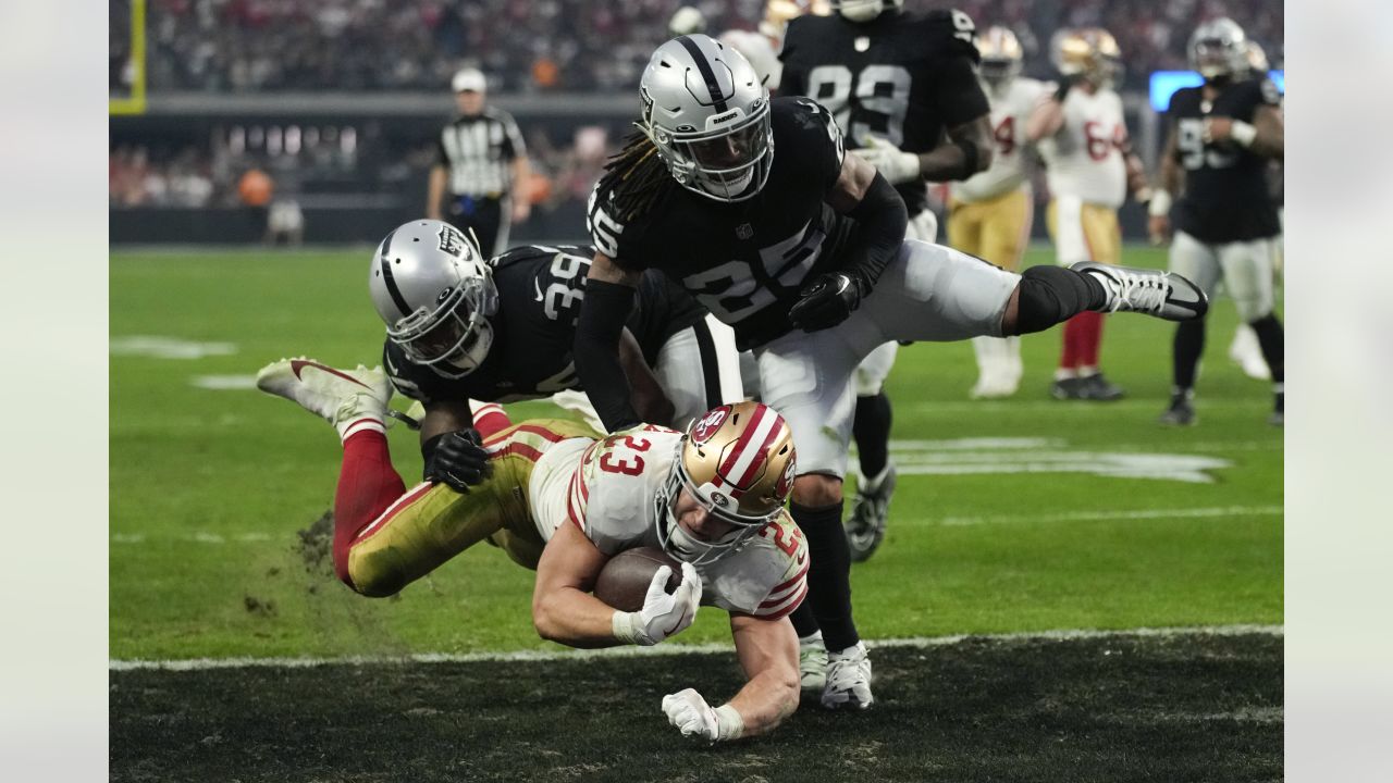 Christian McCaffrey of the San Francisco 49ers is tackled by Kaden