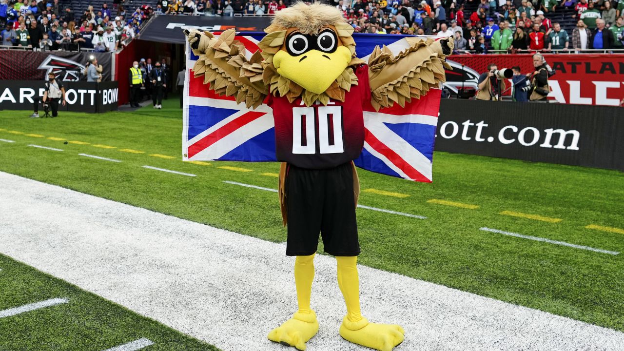 Atlanta Falcons fans pose for photos with team mascot Freddie the